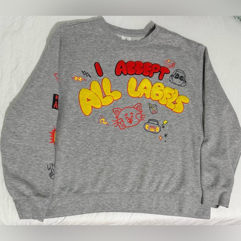 Disney Pixar Turning Red pullover sweatshirt, featuring chenille appliqué text